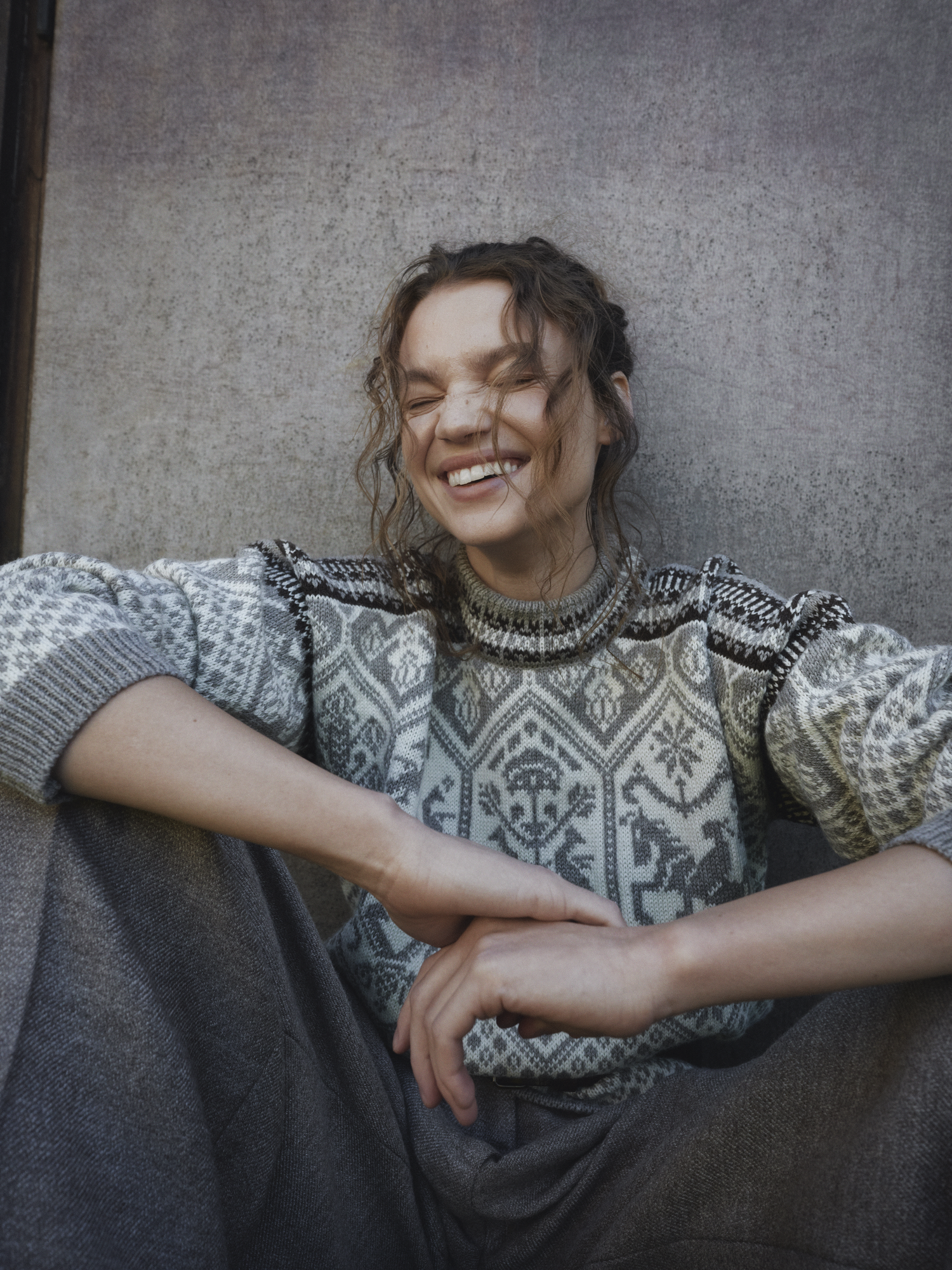 Smiling model wearing Olympic Sweater from Dale of Norway